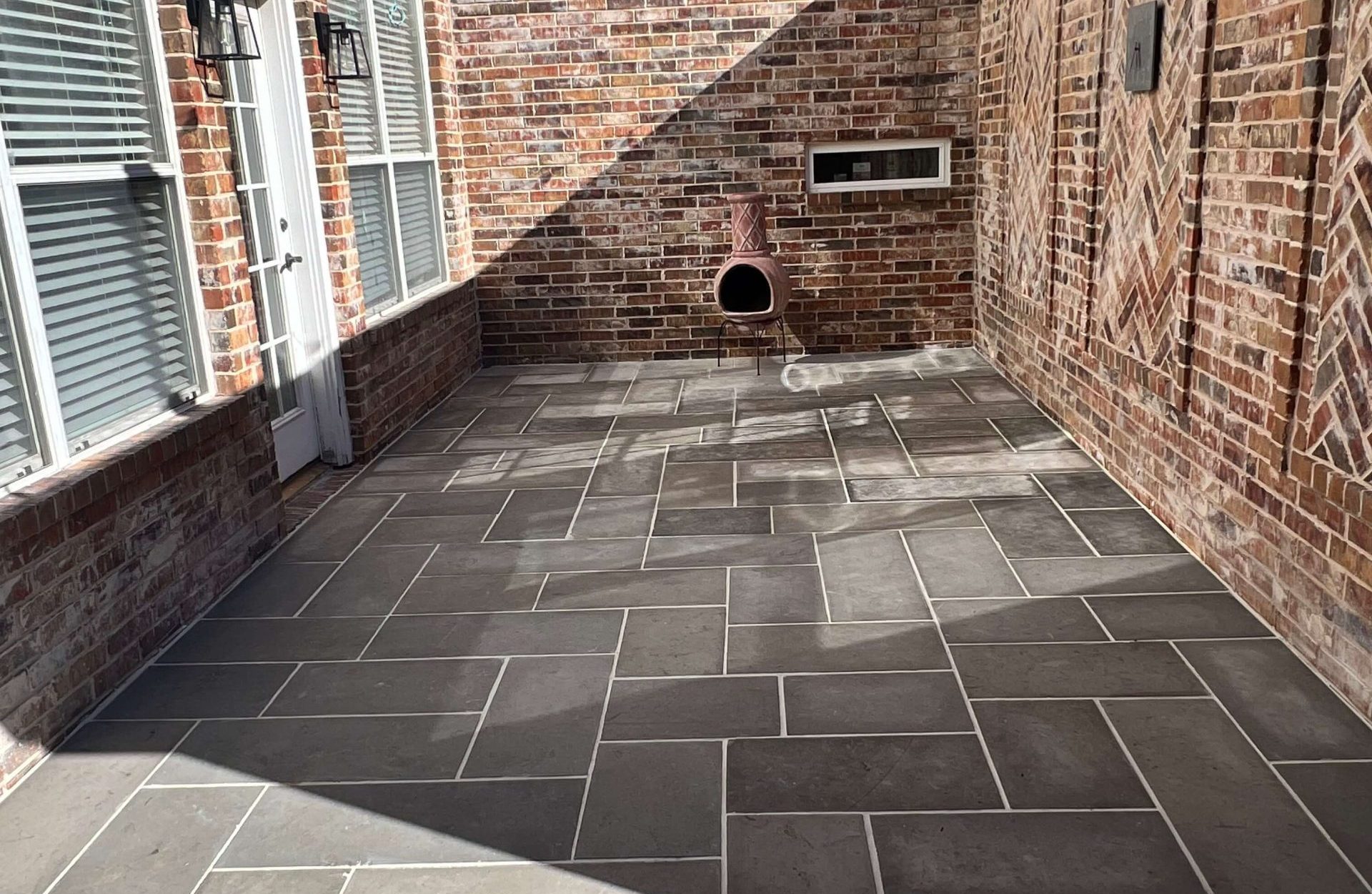 Flagstone patio laid against a brick elevation